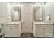 Bathroom featuring dual sinks with white cabinets and grey countertops at 365 Delburg St, Davidson, NC 28036