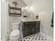 Bathroom with dark wood vanity and honeycomb tile flooring at 365 Delburg St, Davidson, NC 28036