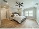 Bedroom with a ceiling fan, a hanging chair, and hardwood floors at 365 Delburg St, Davidson, NC 28036