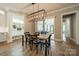 Elegant dining room with modern lighting fixture and view to outdoor living space at 365 Delburg St, Davidson, NC 28036