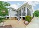 Exterior of home with screened-in porch, stairs, and landscaped backyard with rock and gravel at 365 Delburg St, Davidson, NC 28036
