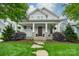 Beautiful home featuring a large front porch with decorative columns and well-manicured lawn at 365 Delburg St, Davidson, NC 28036