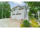 Exterior view of a two-car garage with white doors and an upper-level living space with private entry at 365 Delburg St, Davidson, NC 28036