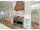 Modern kitchen showcasing stainless steel appliances, custom range hood and white cabinetry at 365 Delburg St, Davidson, NC 28036