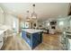 Open-concept kitchen with a large island, stainless appliances, and a view into the living room at 365 Delburg St, Davidson, NC 28036