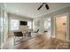 Cozy living room with hardwood floors, a TV, and a view into the bedroom and bathroom at 365 Delburg St, Davidson, NC 28036
