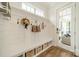 Charming mudroom features shiplap walls, built-in bench and storage for added convenience at 365 Delburg St, Davidson, NC 28036