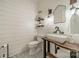 Stylish powder room featuring shiplap walls, industrial-style fixtures, and a unique vessel sink on a wooden vanity at 365 Delburg St, Davidson, NC 28036