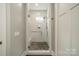 Walk-in shower with pebble floor and subway tile, offering a luxurious bathing experience at 365 Delburg St, Davidson, NC 28036