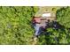 An aerial view of a home surrounded by trees. Roof is partially visible, as is a camper at 3919 Sarah Dr # 14, Charlotte, NC 28217