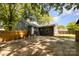 Fenced backyard features a well-maintained lawn, and mature trees, offering a private outdoor space at 3919 Sarah Dr # 14, Charlotte, NC 28217