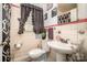 Well-lit bathroom with a pedestal sink, tiled walls, and modern fixtures creates a comfortable and functional space at 3919 Sarah Dr # 14, Charlotte, NC 28217