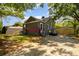 View of a single-story house, a detached carport, a parked car in the driveway, a fenced backyard and mature trees at 3919 Sarah Dr # 14, Charlotte, NC 28217