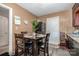 Eat-in kitchen featuring warm tones and a breakfast table at 3919 Sarah Dr # 14, Charlotte, NC 28217