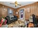 Cozy living room with wood paneled walls, ceiling fan and comfortable seating provides an inviting space for relaxation at 3919 Sarah Dr # 14, Charlotte, NC 28217
