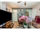 A cozy living room with comfortable seating, a ceiling fan, a large TV and a glass coffee table at 3919 Sarah Dr # 14, Charlotte, NC 28217