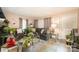 A spacious living room with comfortable seating, two sofas, glass coffee tables, and lots of plants at 3919 Sarah Dr # 14, Charlotte, NC 28217