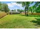 Expansive backyard with lush green grass, wooden fence, and mature trees perfect for outdoor activities at 4009 Dunwoody Dr, Charlotte, NC 28215