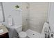 Bright bathroom with tiled shower and a modern shelf and towel rack at 4009 Dunwoody Dr, Charlotte, NC 28215