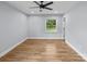 Comfortable bedroom with hardwood floors, ceiling fan, and a serene view from the window at 4009 Dunwoody Dr, Charlotte, NC 28215