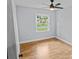 Sunny bedroom with hardwood floors, ceiling fan, and large window overlooks backyard at 4009 Dunwoody Dr, Charlotte, NC 28215