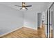 Spacious bedroom featuring hardwood floors, a ceiling fan, and access to a walk-in closet at 4009 Dunwoody Dr, Charlotte, NC 28215