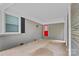 Carport features a red door, gray walls, and a concrete floor at 4009 Dunwoody Dr, Charlotte, NC 28215