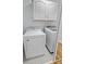 Bright laundry room with white appliances and cabinets offering practical storage solutions at 4009 Dunwoody Dr, Charlotte, NC 28215