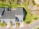 Aerial view of home with gray shingled roof, patio, green lawn, and driveway parking at 4015 Broadview Ln, Gastonia, NC 28056