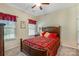 This bedroom features natural light, and a decorative red comforter at 4015 Broadview Ln, Gastonia, NC 28056