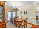 Dining room with hardwood floors, chandelier, and natural light from the door's window at 4015 Broadview Ln, Gastonia, NC 28056
