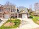 Charming brick townhome with manicured front yard, front-entry two-car garage, and a cozy front porch at 4015 Broadview Ln, Gastonia, NC 28056