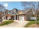 Charming brick townhome with manicured front yard, front-entry two-car garage, and a cozy front porch at 4015 Broadview Ln, Gastonia, NC 28056