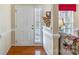 Bright foyer with hardwood flooring, wainscoting, and a charming plant display, leading to living spaces at 4015 Broadview Ln, Gastonia, NC 28056