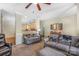 Spacious living room features neutral carpet, crown molding, and an array of comfortable seating options at 4015 Broadview Ln, Gastonia, NC 28056