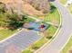 Aerial view of community playground with colorful equipment, parking and sidewalks at 4015 Broadview Ln, Gastonia, NC 28056