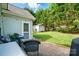 Landscaped backyard features a stone patio with outdoor seating and a shed for extra storage at 503 Azure Ave, Albemarle, NC 28001