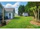 Expansive backyard featuring a shed and a trampoline, bordered by lush trees and greenery at 503 Azure Ave, Albemarle, NC 28001