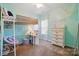 Aqua bedroom featuring a lofted bed with a desk and dresser, bathed in natural light from the window at 503 Azure Ave, Albemarle, NC 28001
