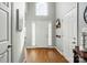 Bright foyer featuring hardwood floors, high ceilings, a large window, and a white front door at 503 Azure Ave, Albemarle, NC 28001