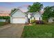 Charming single-Gathering home featuring a two-car garage, well-maintained lawn, and traditional siding at dusk at 503 Azure Ave, Albemarle, NC 28001