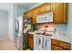 Bright kitchen with stainless steel refrigerator and an electric stove with overhead microwave oven at 503 Azure Ave, Albemarle, NC 28001
