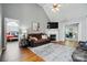 Cozy living room with hardwood floors, a ceiling fan, a fireplace, and comfortable seating at 503 Azure Ave, Albemarle, NC 28001