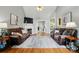Spacious living room features high ceilings, a ceiling fan, hardwood floors, and a cozy fireplace at 503 Azure Ave, Albemarle, NC 28001