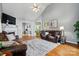 Open-concept living room with high ceilings, hardwood floors, cozy seating, and fireplace at 503 Azure Ave, Albemarle, NC 28001