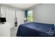 Comfortable bedroom with a window view and closet, enhanced by a modern dresser at 513 Lex Dr, Charlotte, NC 28262