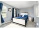 Cozy bedroom featuring neutral walls, plush carpet, and a comfortable bed with stylish navy bedding at 513 Lex Dr, Charlotte, NC 28262
