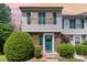 Charming townhome with green door and shutters, complemented by lush landscaping and brick accents at 513 Lex Dr, Charlotte, NC 28262