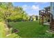 Spacious backyard with a fire pit, garden, shed, and well-maintained lawn at 5301 Meadowcroft Way, Fort Mill, SC 29708