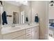 Neutral-toned bathroom featuring double sinks, a large mirror, and lots of counter space at 5301 Meadowcroft Way, Fort Mill, SC 29708